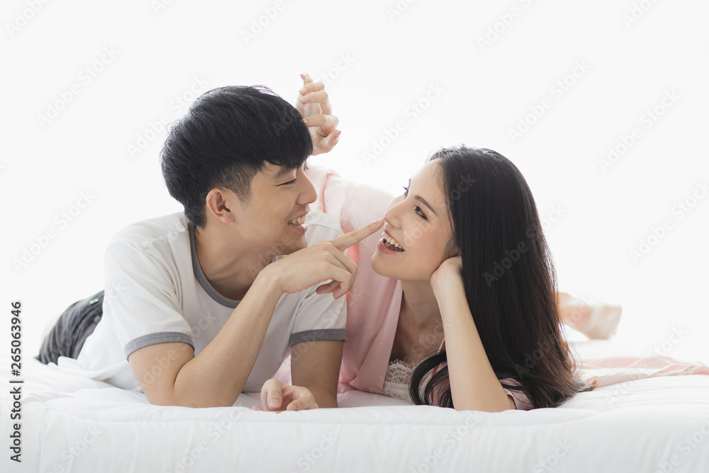 Asian couple spending time together on the bed.. Asian couple spending time together on the bed..