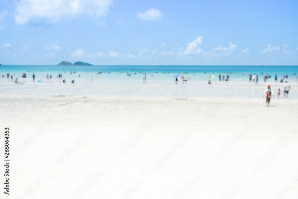 Blur group of people are doing activity on the beach with sand sea and bright sky with sunshine day. for background. Blur group of people are doing activity on the beach with sand sea and bright sky with sunshine day. for background.