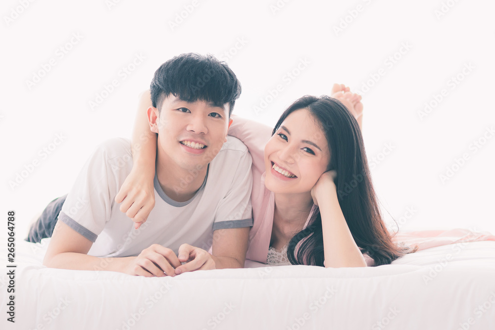 Asian couple spending time together on the bed.. Asian couple spending time together on the bed..