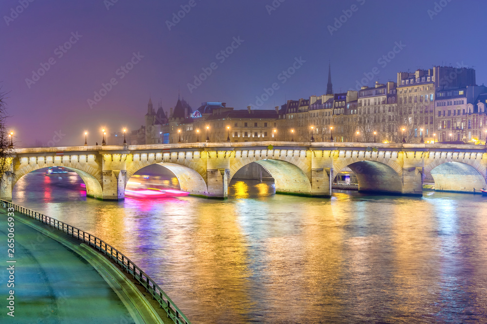 Night view of  Paris, France. Illuminated Pont neuf (New Bridge) is oldest bridge across the river Seine.