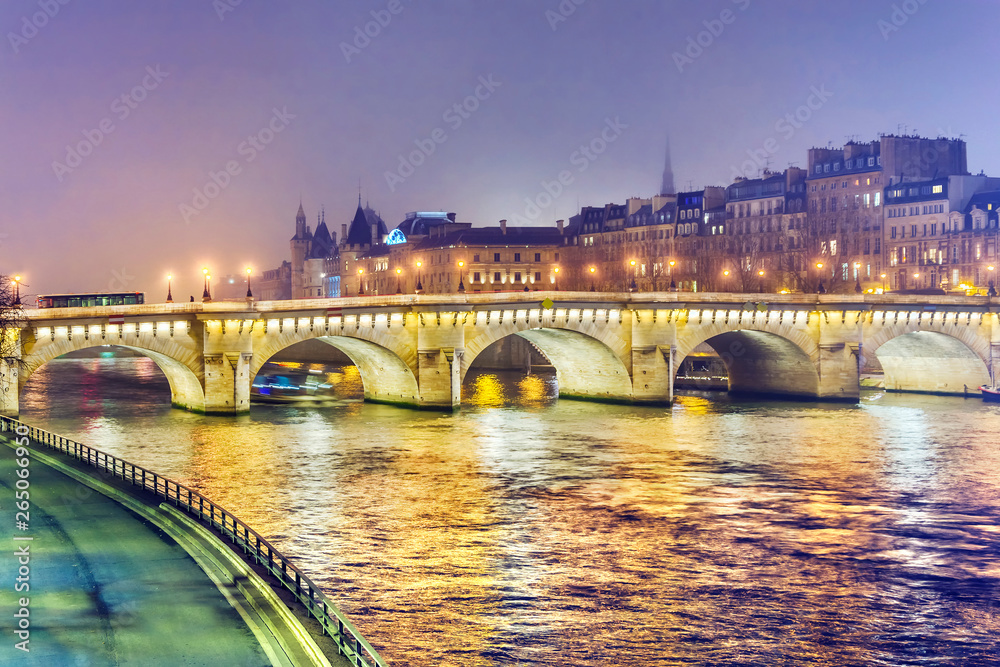 Night view of  Paris, France. Illuminated Pont neuf (New Bridge) is oldest bridge across the river Seine.
