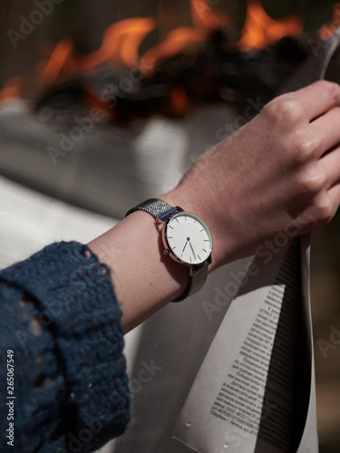 Stylish photograph of a watch with white dial.