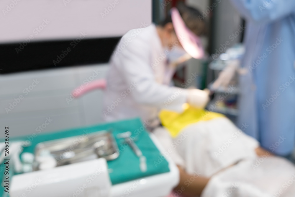 Blurred image photo of dentist and his assistant are working in clinic. Blurred image photo of dentist and his assistant are working in clinic.