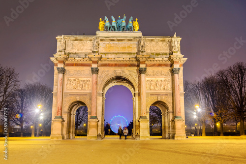 Triumphal Arch (Arc de Carrousel) located between Louvre and Tuileries Garden (Jardin des Tuileries) in Paris at night, France © MarinadeArt