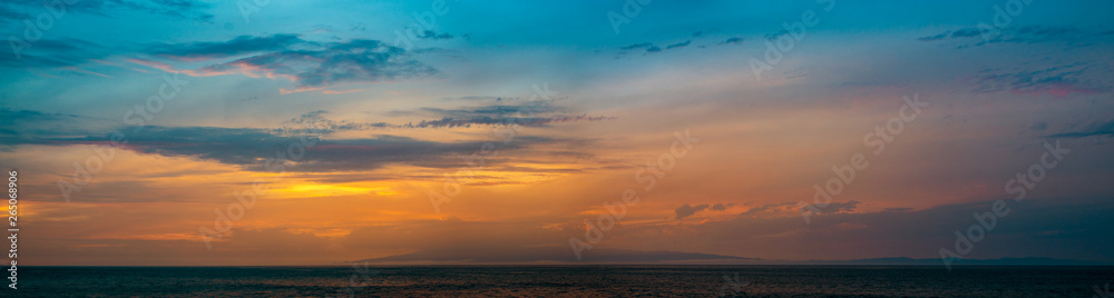 beautiful, multicolored sunset over the ocean, Tenerife visible on the horizon