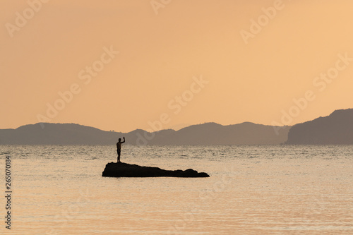 Human silhouette at Phi Phi beach during sunset in Krabi province, Thailand photo