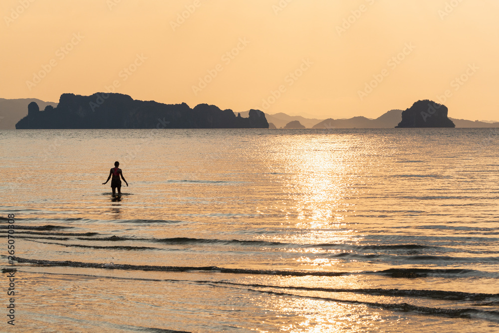 Human silhouette at Phi Phi beach during sunset in Krabi province, Thailand