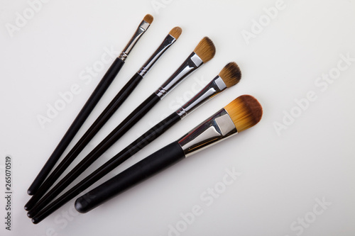 Brushes for make-up, make-up tools. Make-up artist. Brushes laid on the table. view from above. Usage: Advertisement, poster, brochure, sticker. top view