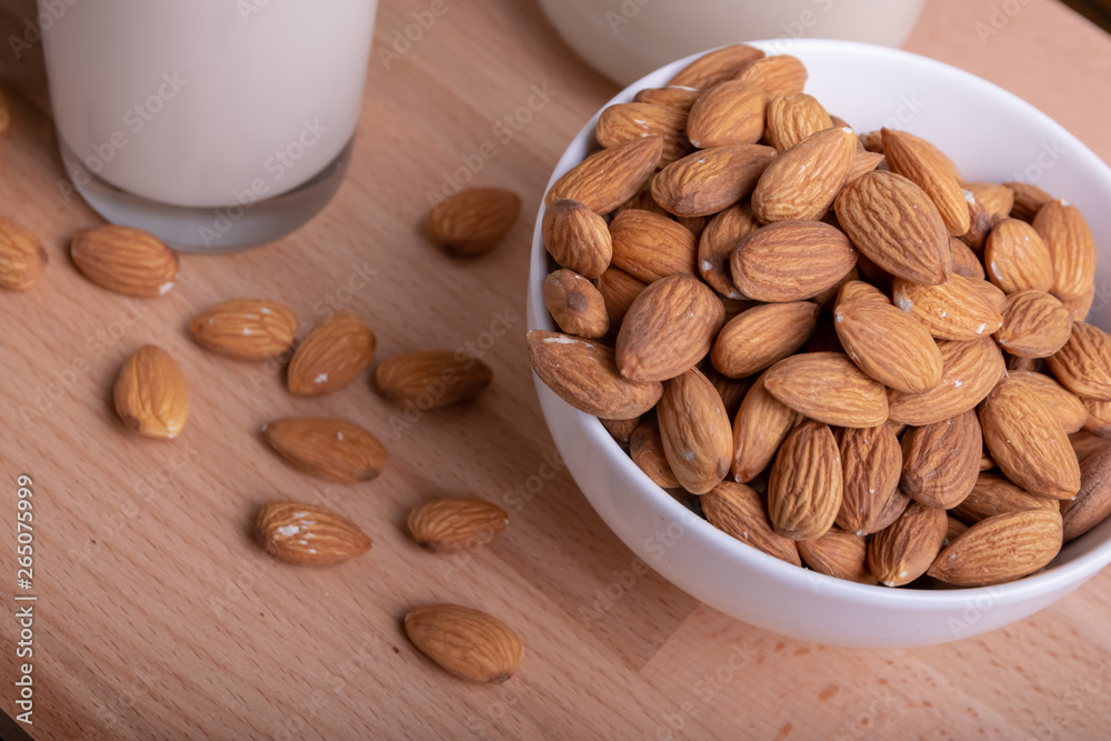 Glass of Milk Almond milk and organic almonds on wooden background, Alternative Milk. Nuts milk Glass of Milk Almond milk and organic almonds on wooden background, Alternative Milk. Nuts milk