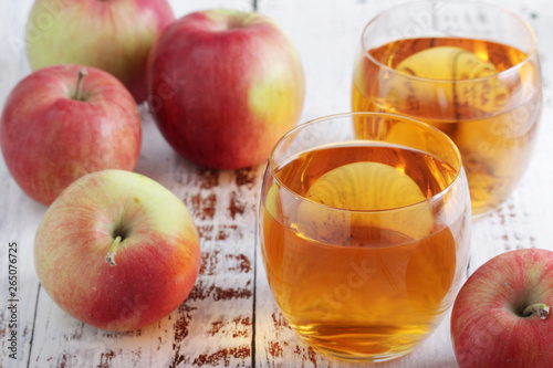 Several apples and glasses with apple juice