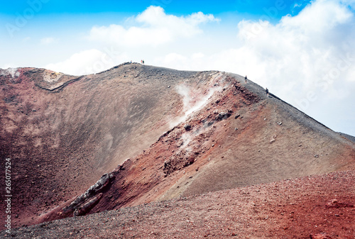 People walking on Mount Etna, active volcano on the east coast of Sicily, Italy.