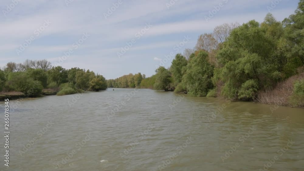 Nature Reserve Delta of the Danube River. A cruise ship swims along the river. Romania. Spring high water. Beautiful seacoast. Rich vegetation. Nature Reserve Delta of the Danube River. A cruise ship swims along the river. Romania. Spring high water. Beautiful seacoast. Rich vegetation.