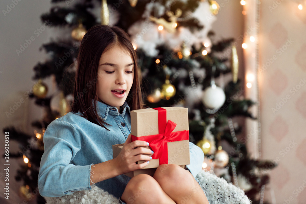 Happy child girl opening christmas gift box