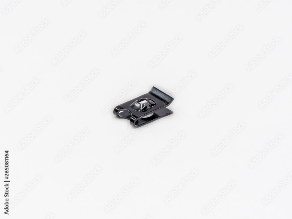 Black zinc coated spring nut for tapping screrw shot on white.
