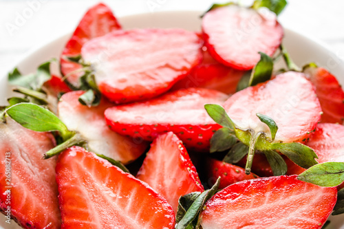 Fresh strawberries. Plate with juicy strawberry slices.