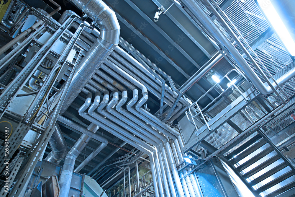 Fototapeta premium Industrial Steel pipelines, valves, cables and walkways