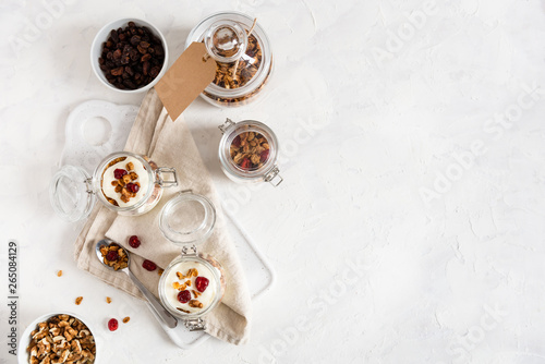 Dry breakfast cereals. Crunchy honey granola bowl with flax seeds, cranberries and yogurt. Healthy and fiber food. Breakfast time. Dieting. Flat lay, copy space © Dina Photo Stories