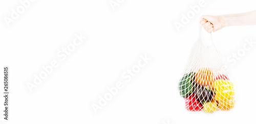 Woman hand holding a shopping bag with vegetables, fruits on a white background 