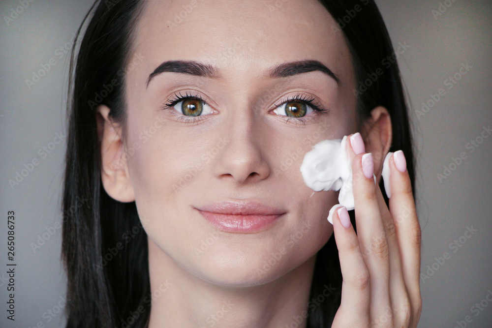 girl cleans face with facial cleanser girl cleans face with facial cleanser