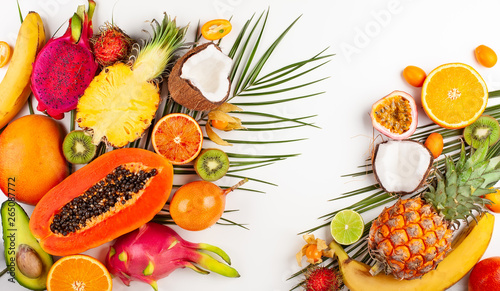 Still life with fresh assorted exotic fruits on a palm leaf.