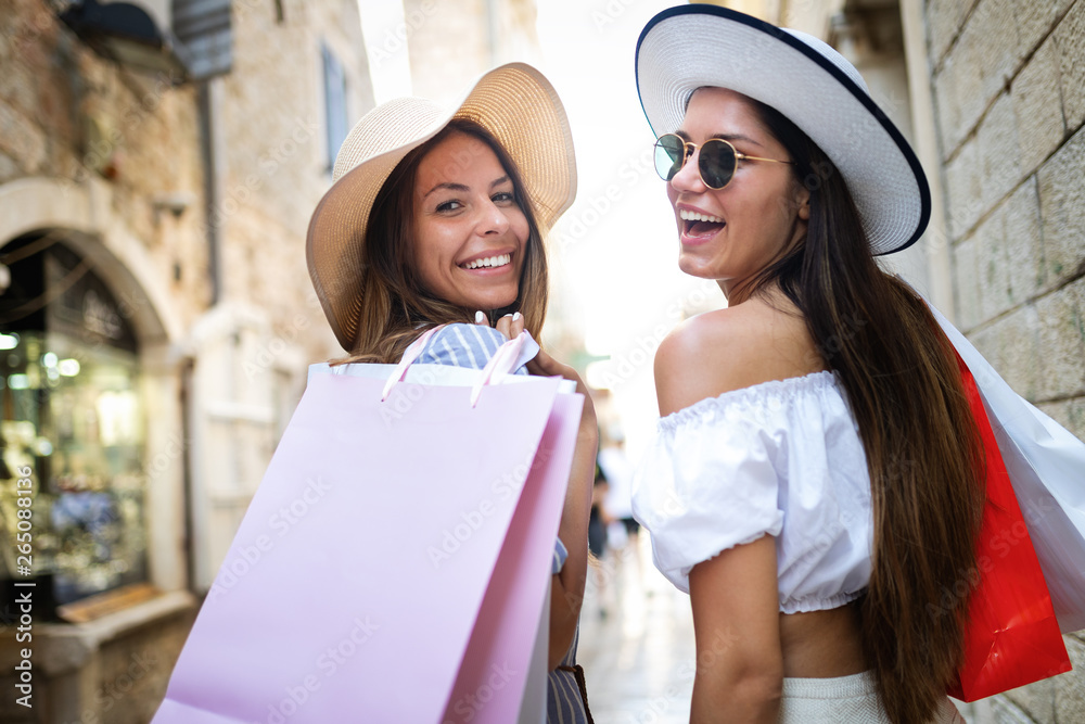 Happy friends women shopping in the city on vacation Happy friends women shopping in the city on vacation