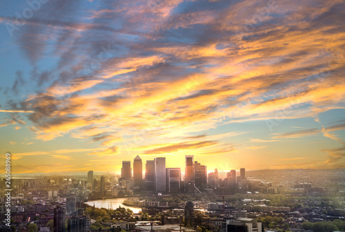 Canary Wharf at sunset, London, UK. Skyline view of the famous financial bank district at golden sunset. View includes skyscrapers, office buildings and beautiful sky and river Thames.  © IRStone