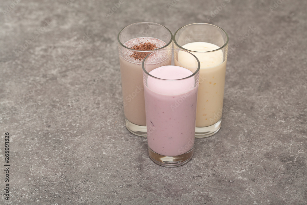 Assorted protein cocktails. Strawberry, banana and chocolate protein shakes. Sports nutrition and healthy lifestyle concept.