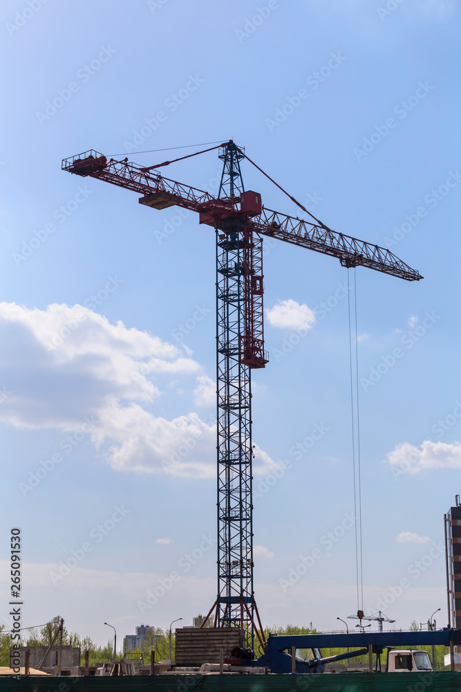 Construction crane against blue sky. Urban spring landscape. Construction site. Construction crane against blue sky. Urban spring landscape. Construction site.