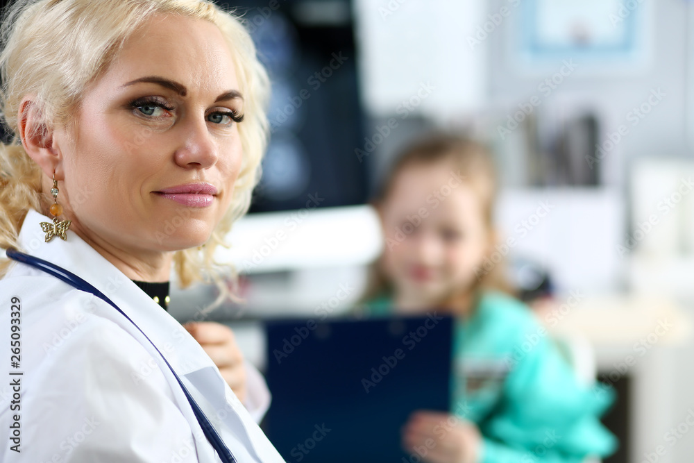 Mature blonde doctor at her office receiving little patient Mature blonde doctor at her office receiving little patient