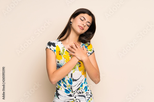 Teenager girl with floral dress having a pain in the heart
