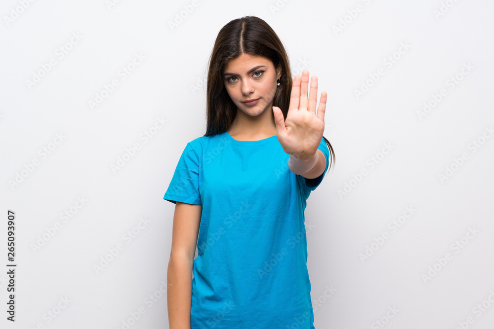 Teenager girl with blue shirt making stop gesture Teenager girl with blue shirt making stop gesture