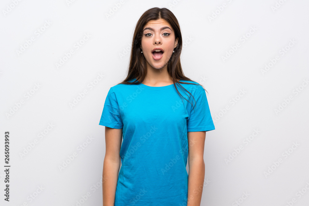 Teenager girl with blue shirt with surprise facial expression Teenager girl with blue shirt with surprise facial expression