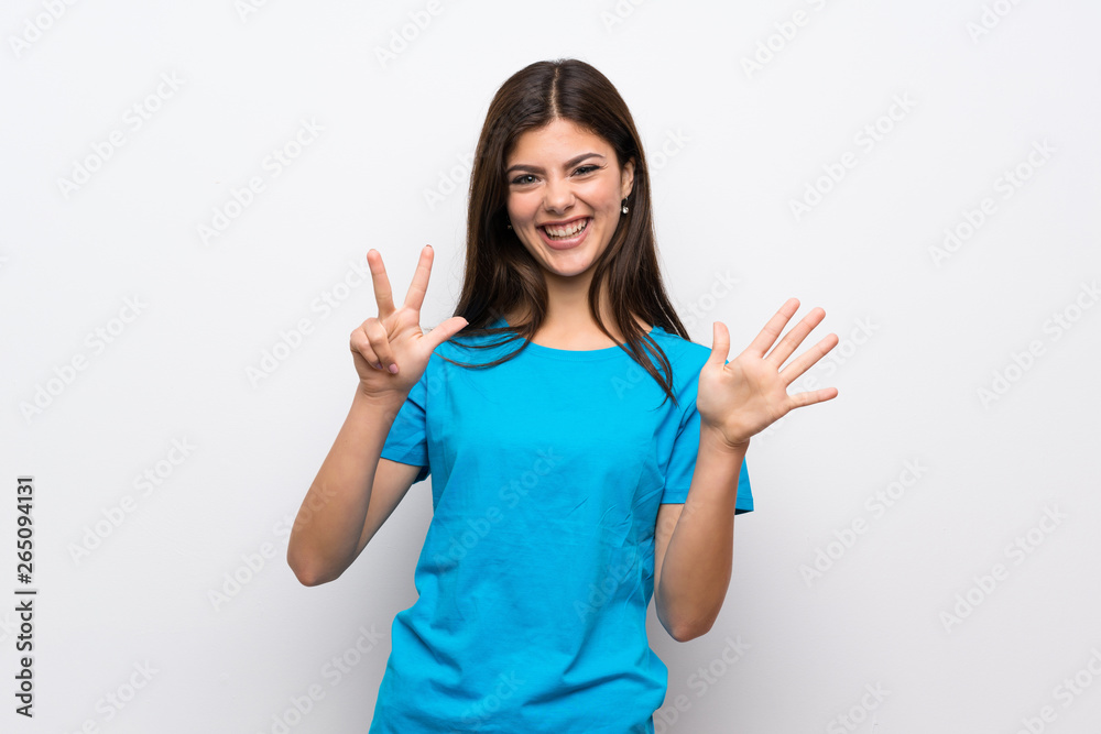 Teenager girl with blue shirt counting eight with fingers Teenager girl with blue shirt counting eight with fingers
