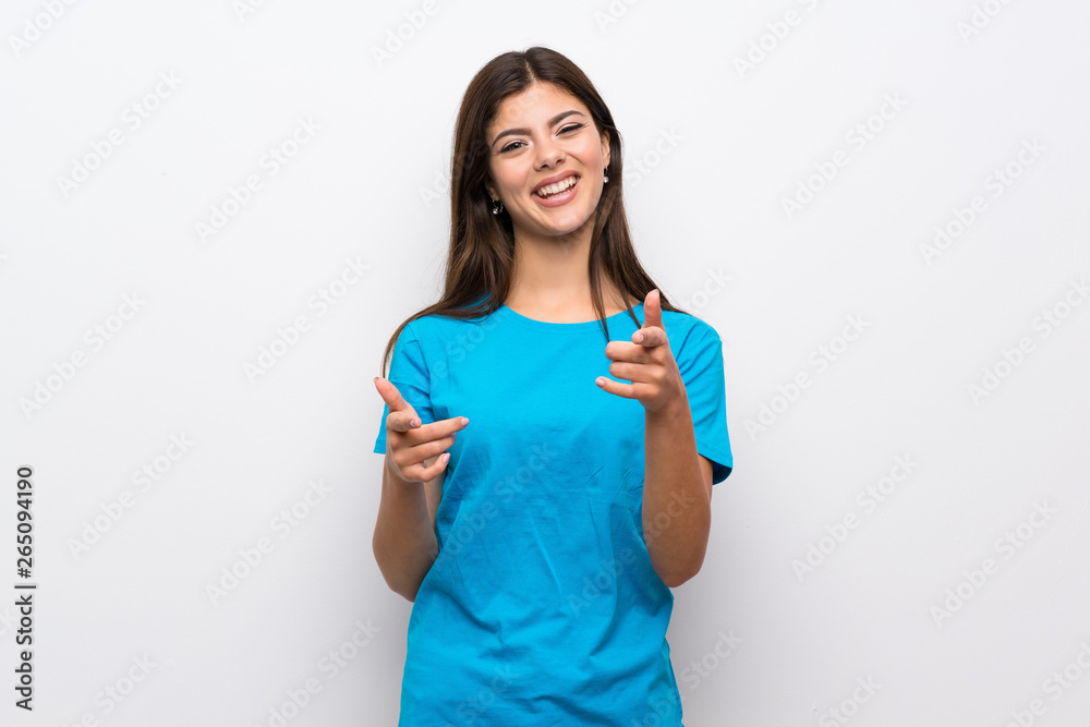 Teenager girl with blue shirt pointing to the front and smiling Teenager girl with blue shirt pointing to the front and smiling