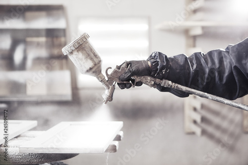 Fototapeta Naklejka Na Ścianę i Meble -  Staining wood with white spray gun. Application of flame retardant ensuring fire protection, airless spraying device.