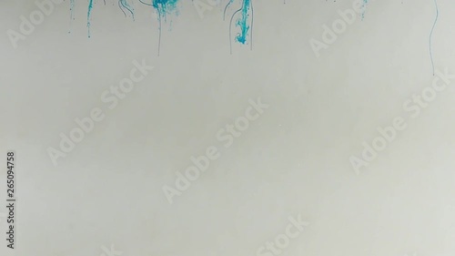 Drop of blue paint into water from above, slow diffusion.