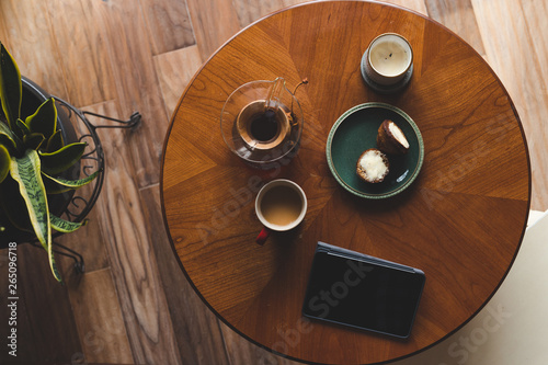 Wallpaper Mural A top down shot of modern living room coffee table with a coffee cup, book, tablet, and a muffin on it. Torontodigital.ca