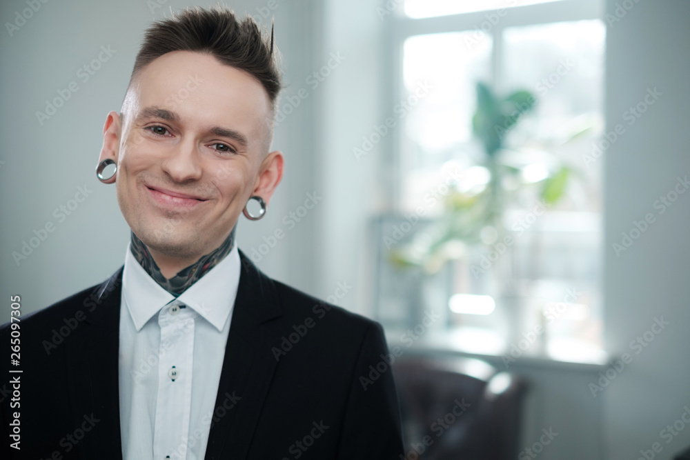 Portrait of alternative model with earplugs and tattoo Portrait of alternative model with earplugs and tattoo