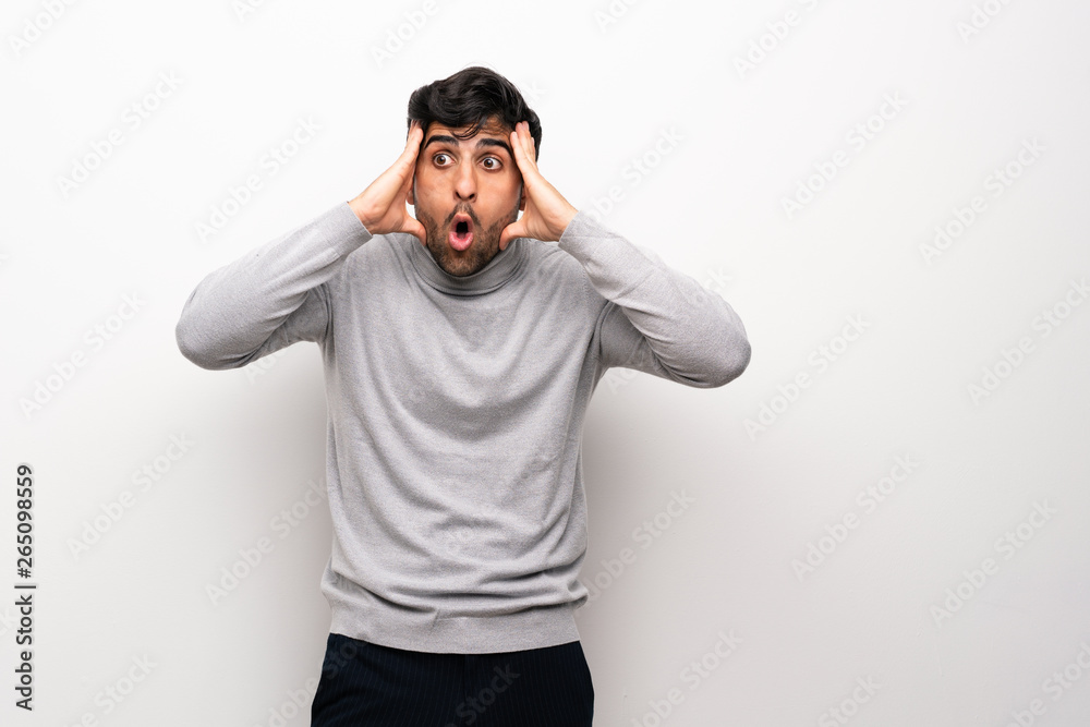 Fototapeta premium Young man over isolated white wall with surprise expression