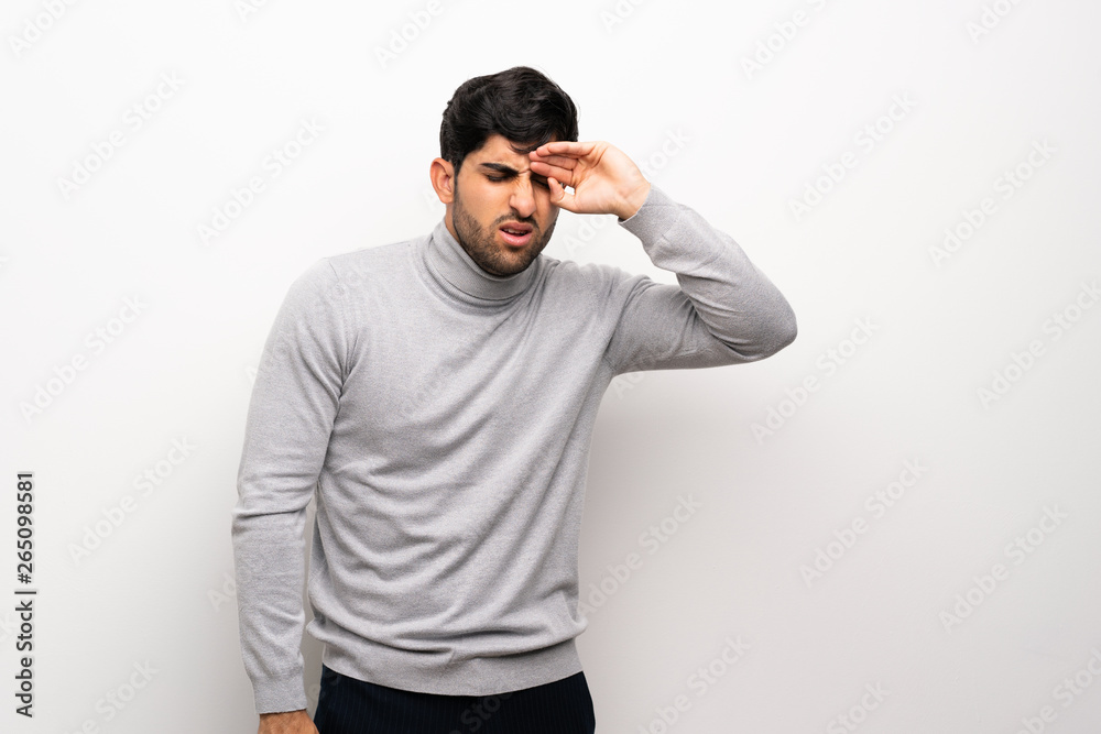 Young man over isolated white wall with tired and sick expression Young man over isolated white wall with tired and sick expression