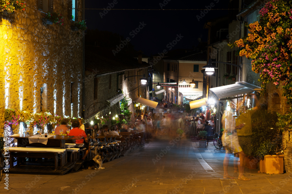 Castiglione della Pescaia, Italy - September 9, 2014: People and tourist walking and have dinner at night. 