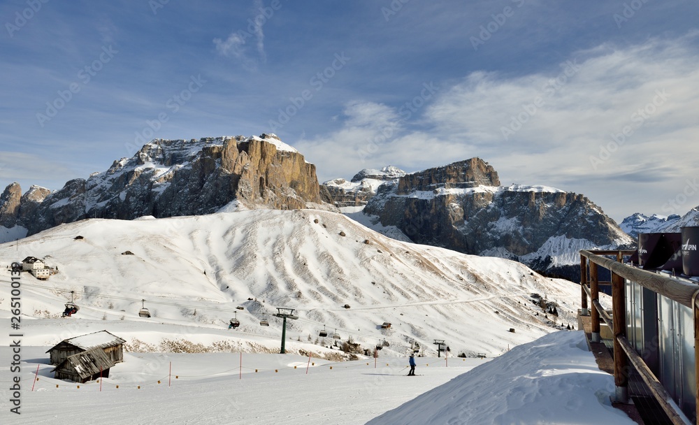 Skiers going down the slope at Val Di Fassa ski resort in Italy