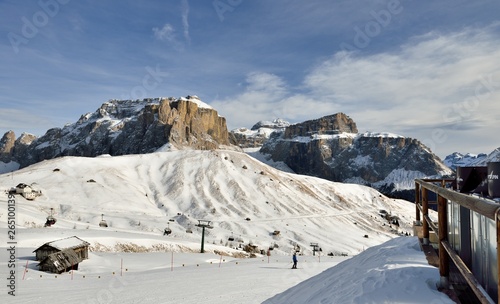 Skiers going down the slope at Val Di Fassa ski resort in Italy