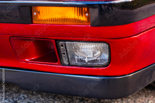 Fog light of a red, old, retro car