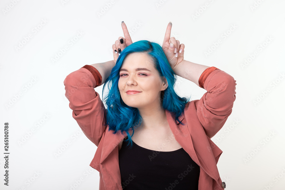 People, fun and hair concept - beautiful girl with blue hair having fun standing on white background