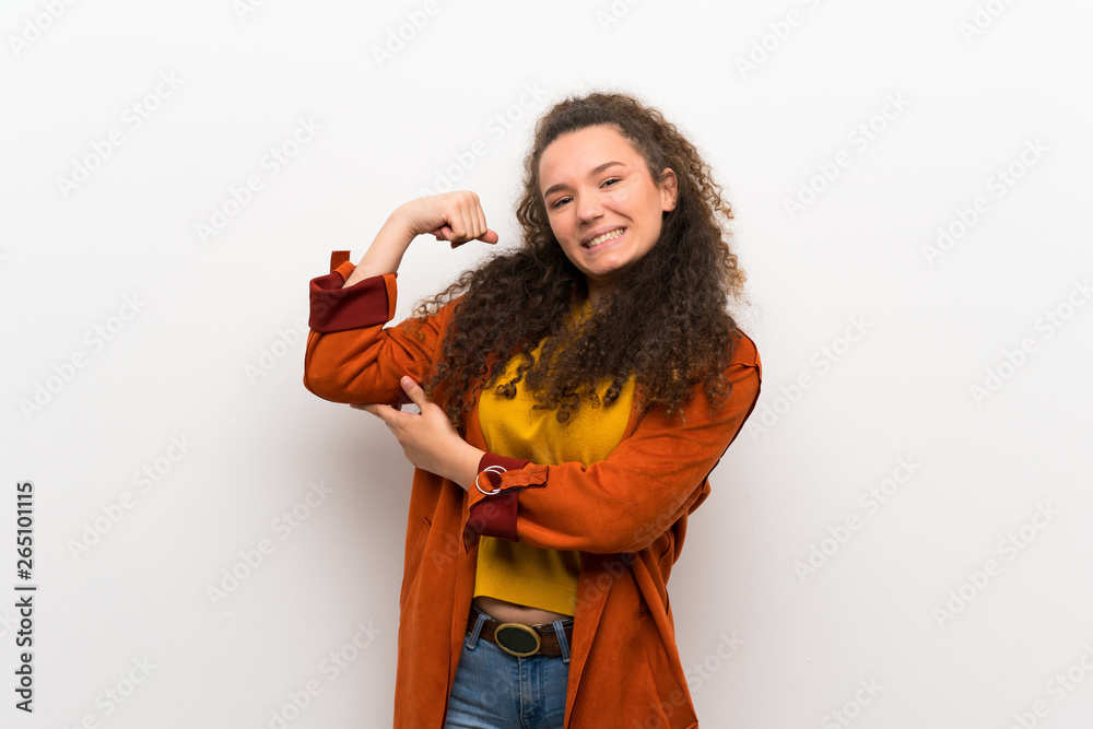 Teenager girl with coat doing strong gesture Teenager girl with coat doing strong gesture