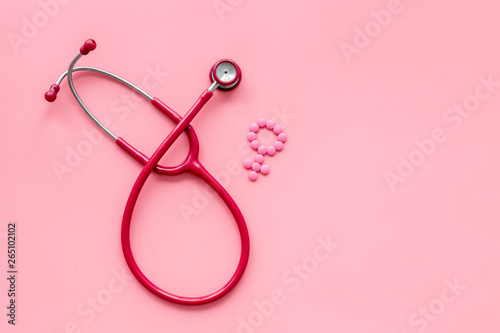 diagnostic and cure of gynaecological disease with stethoscope and female symbol on pink background top view mock-up photo