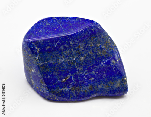 Blue polished shiny lapis lazuli stone mineral specimen with golden inclusions isolated on white limbo background photo