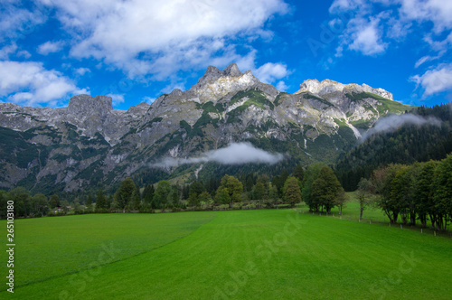 Austrian Verfenveg village Alps mountains autumnal scenery with fog, green meadows and rocks © Iva