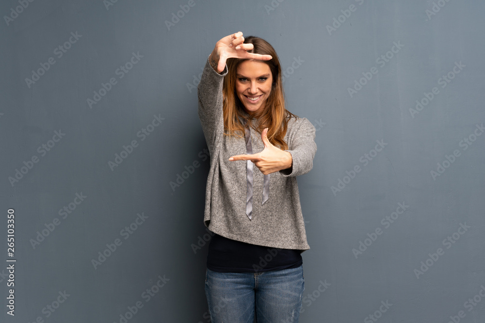 Blonde woman over grey background focusing face. Framing symbol Blonde woman over grey background focusing face. Framing symbol